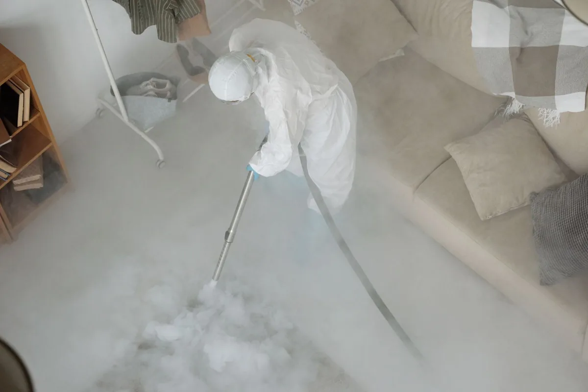 Biohazard cleanup technician in protective equipment, Corsicana, TX